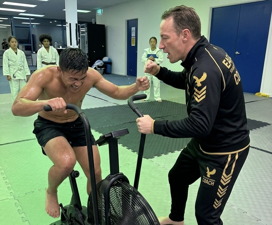 Dafydd Sanders coaching a client through assault bike conditioning work